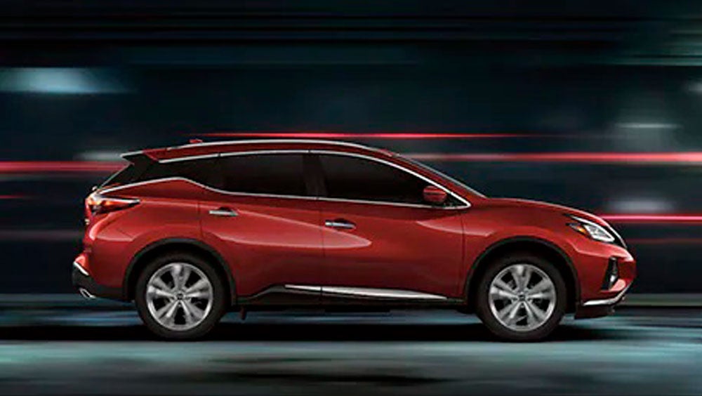 2023 Nissan Murano shown in profile driving down a street at night illustrating performance. | Alpine Nissan in Denver CO